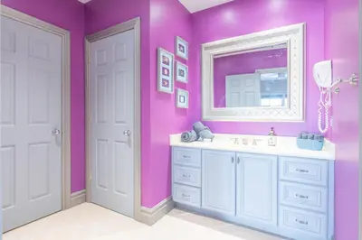 a pink bathroom with a sink and a mirror at Lux Lakeside Escape Slps 20 with Pool, Golf Sim, Hot Tub, Karaoke, Gym and Sauna in Peterborough
