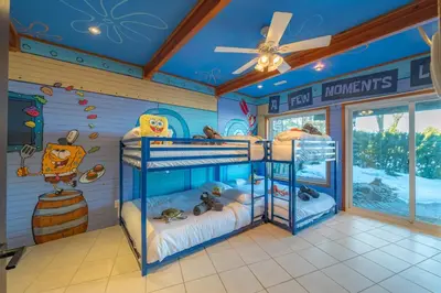 a bedroom with two bunk beds in a room at Lux Lakeside Escape Slps 20 with Pool, Golf Sim, Hot Tub, Karaoke, Gym and Sauna in Peterborough