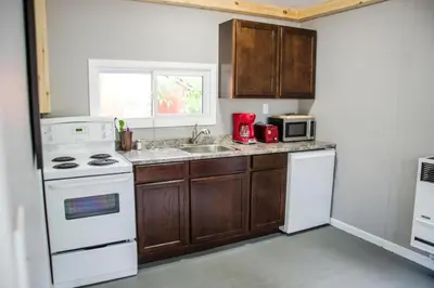 a kitchen with a white stove and a sink at Westlake Waupoos Cottage in Wellington