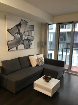 a living room with a couch and a table at Chic Toronto Blue Jays Getaway in Toronto