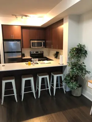 a kitchen with a large island with bar stools at Chic Toronto Blue Jays Getaway in Toronto