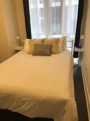 a large white bed with a pillow on top of it at Chic Toronto Blue Jays Getaway in Toronto