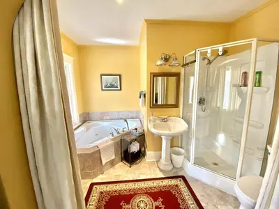 a bathroom with a tub and a sink and a shower at Two bedrooms unit with jacuzzi in Niagara Falls