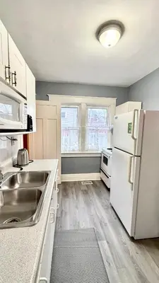 a kitchen with a sink and a white refrigerator at Entire guest suite in the Falls in Niagara Falls