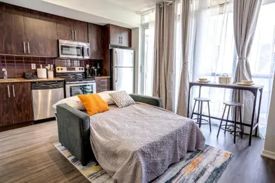 a kitchen with a bed in the middle of a room at Exquisite Living Toronto in Toronto