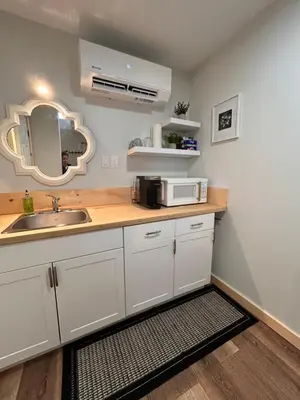 a kitchen with a sink and a microwave on a counter at Smokehouse Suites and Stay in Guelph