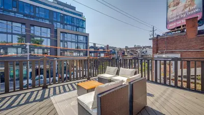 a balcony with two couches on a building at Urban Oasis, 3-Bedroom Apartment at Prime Location in Toronto