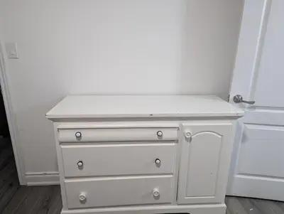 a white dresser sitting next to a door at Basement two Queen beds and one single with two full washrooms by YKF airport in Kitchener