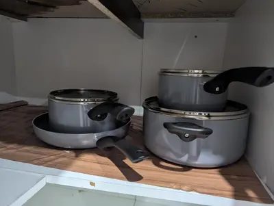 a kitchen with two pots on top of a counter at Basement two Queen beds and one single with two full washrooms by YKF airport in Kitchener