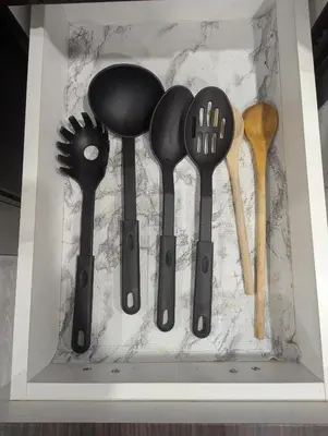 a group of utensils in a wooden box at Basement two Queen beds and one single with two full washrooms by YKF airport in Kitchener