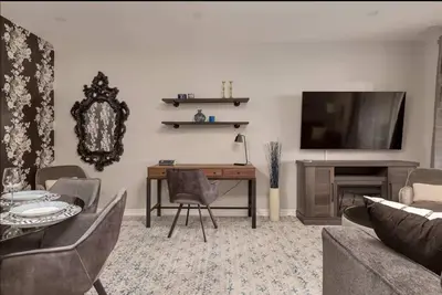 a living room with a desk and a tv at Casa Hotel Elegant Suite w Patio BBQ Grill in Toronto