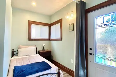 a bedroom with a bed and a window at Cozy Suite-Walk to the Falls in Niagara Falls