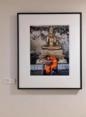 a man sitting in front of a statue in a framed picture at The Studio Southampton in Southampton