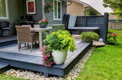 a patio with a table and chairs and flowers at The Studio Southampton in Southampton