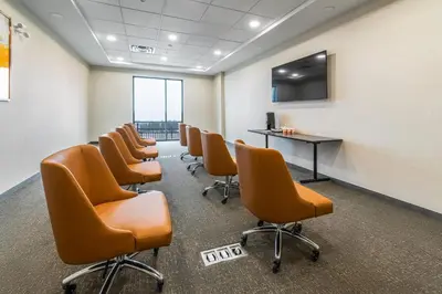 a waiting room with a row of chairs and a table at Comfort Inn & Suites in Bradford