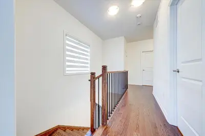 a hallway with a staircase and a window at West Oak, Detached New Modern House In South Barrie - Built H plus ME Technology in Barrie