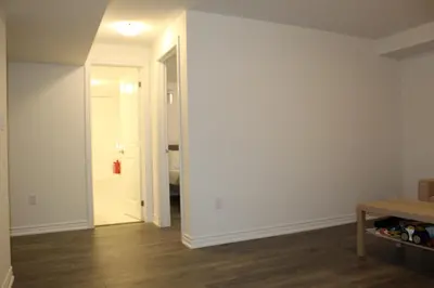 an empty room with a door leading to a bedroom at West Oak, Detached New Modern House In South Barrie - Built H plus ME Technology in Barrie