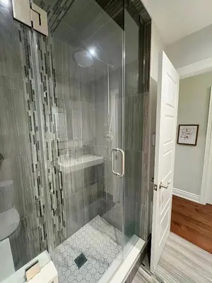 a shower with a glass door in a bathroom at Chapman in Toronto