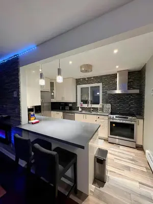 a large kitchen with a large island in the middle at Chapman in Toronto