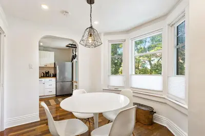 a white dining room with a white table and chairs at Stylish & Spacious 3BR in Downtown Toronto in Toronto