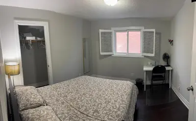 a bedroom with a bed and a desk and a window at Private Single Bedroom in City Centre Q66 in Mississauga