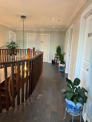 a hallway with a staircase with potted plants at Private Single Bedroom in City Centre Q66 in Mississauga