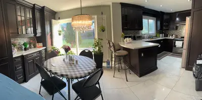 a kitchen with a table and chairs and a dining room at Private Single Bedroom in City Centre Q66 in Mississauga