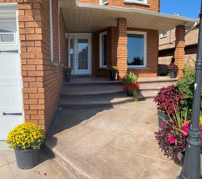 a brick house with a front porch with flowers at Private Single Bedroom in City Centre Q66 in Mississauga