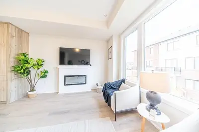 a living room with a fireplace and a tv at Entire home in Oakville, Canada in Oakville
