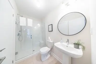 a bathroom with a toilet and a sink and a mirror at Entire home in Oakville, Canada in Oakville