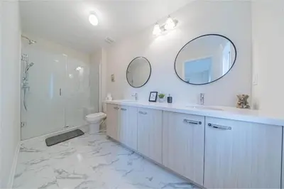a bathroom with a sink and a toilet and a mirror at Entire home in Oakville, Canada in Oakville