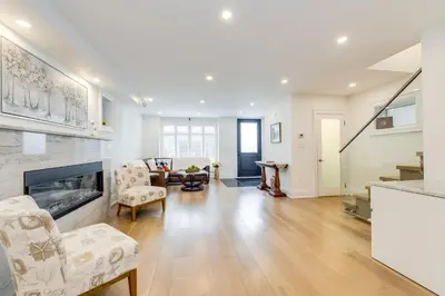 a living room with a couch and chairs and a fireplace at Toronto Midtown Home Suites in Toronto