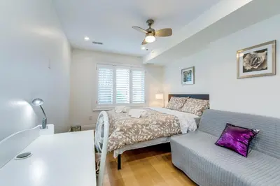 a bedroom with a bed and a couch at Toronto Midtown Home Suites in Toronto