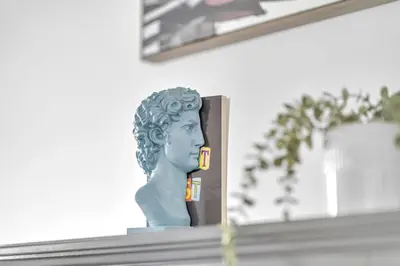a bust of a woman sitting on a mantle at Modern Condo with Balcony, Gym and Free Parking in Toronto
