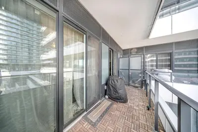 a balcony of a building with a chair on the floor at Modern Condo with Balcony, Gym and Free Parking in Toronto