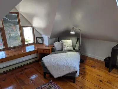 a living room with a chair and a desk at Cozy 2-Bedroom Downtown Apartment in London