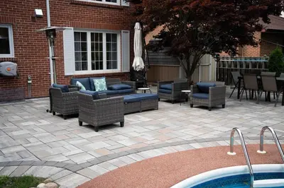 a patio with couches and chairs and a pool at 6 Bedroom Luxury House with a Bright Sunroom in Mississauga