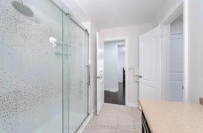 a bathroom with a shower with a glass door at Beautiful 4 bed, 3 master bedrooms-pvt washrooms in Brampton