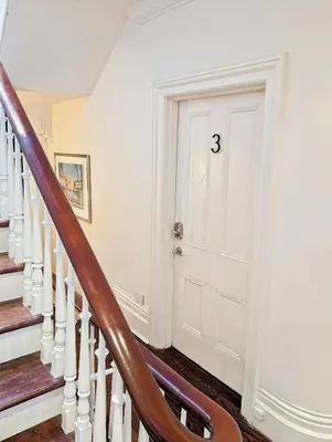 a staircase with a white door in a house at Hazelton Heritage in Toronto