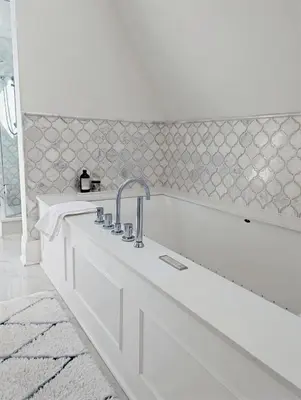 a white bath tub with a faucet in a bathroom at Hazelton Heritage in Toronto