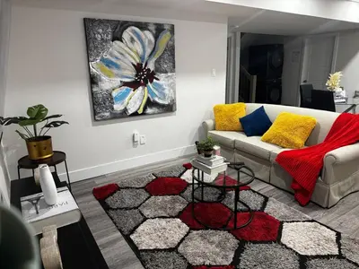 a living room with a couch and a rug at Gateway to Serenity-Welcome home in London