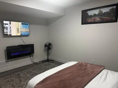 a bedroom with a bed and a flat screen tv at Gateway to Serenity-Welcome home in London