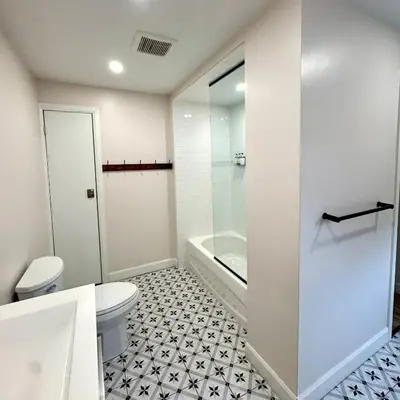 a white bathroom with a toilet and a shower at Blue View Chalets in Blue Mountains
