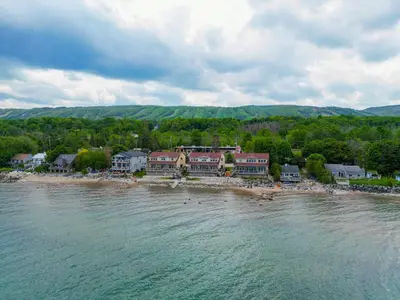 a group of houses on the shore of the water at Blue View Chalets in Blue Mountains