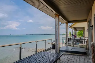 a balcony with a view of the water on a house at Blue View Chalets in Blue Mountains