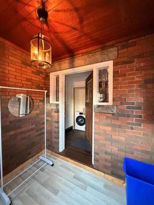 a room with a brick wall and a ceiling at Bright 2bedroom apartment in Hamilton