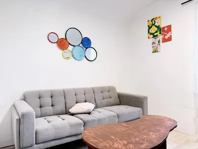 a living room with a couch and a table at Bright 2bedroom apartment in Hamilton