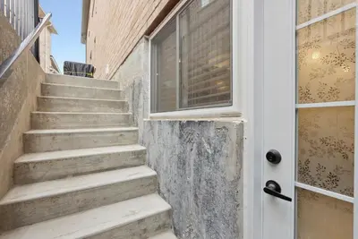 a set of stairs next to a door at Baker Hill Executive Suite 2 Br Basement Apartment with Full Kitchen and Bath in Stouffville