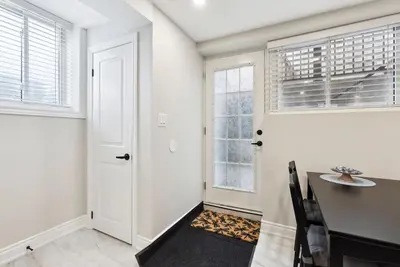 a dining room with a table and a window at Baker Hill Executive Suite 2 Br Basement Apartment with Full Kitchen and Bath in Stouffville