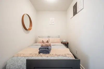 a small bedroom with a bed with a mirror at Apartment in Downtown Toronto in Toronto